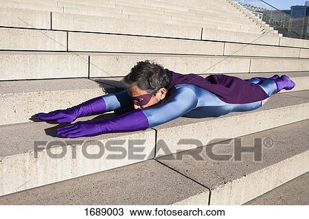 Side view of man dressed as superhero lying on steps View Large Photo Image Stock Image - Side view of man dressed as superhero lying on steps. Fotosearch