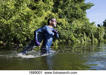 Side view of mature superhero running in river against trees View Large Photo Image Stock Image - Side view of mature superhero running in river against trees. Fotosearch