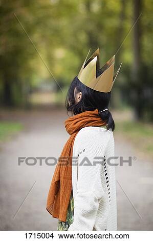 Side view of woman wearing crown while standing at park View Large Photo Image Picture - Side view of woman wearing crown while standing at park. Fotosearch