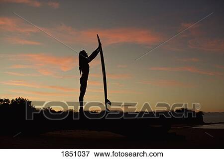Silhouette female surfer with surfboard on beach at dusk View Large Photo Image Stock Photo - Silhouette female surfer with surfboard on beach at dusk. Fotosearch