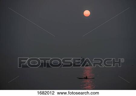 Silhouette freight boats on sea against sky at night View Large Photo Image Stock Image - Silhouette freight boats on sea against sky at night. Fotosearch