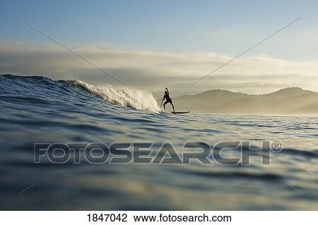 Silhouette paddle boarder riding ocean wave, Sayulita, Nayarit, Mexico View Large Photo Image Stock Image - Silhouette paddle boarder riding ocean wave, Sayulita, Nayarit, Mexico. Fotosearch