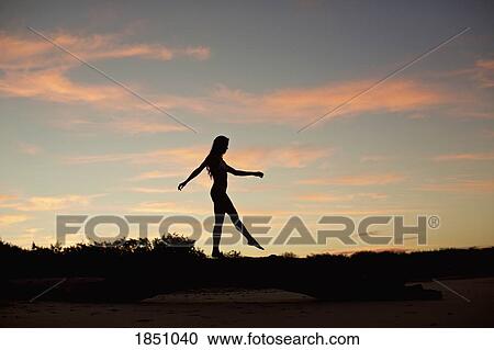 Silhouette woman on beach at dusk View Large Photo Image Stock Image - Silhouette woman on beach at dusk. Fotosearch