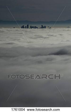 Silhouetted skyscraper buildings above clouds, Vancouver, British Columbia View Large Photo Image Picture - Silhouetted skyscraper buildings above clouds, Vancouver, British Columbia. Fotosearch