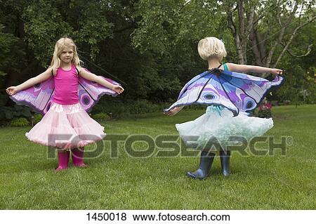 Sisters in butterfly costume playing at backyard View Large Photo Image Stock Photo - Sisters in butterfly costume playing at backyard. Fotosearch