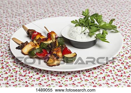 Skewers by sauce served in plate on table View Large Photo Image Stock Photography - Skewers by sauce served in plate on table. Fotosearch
