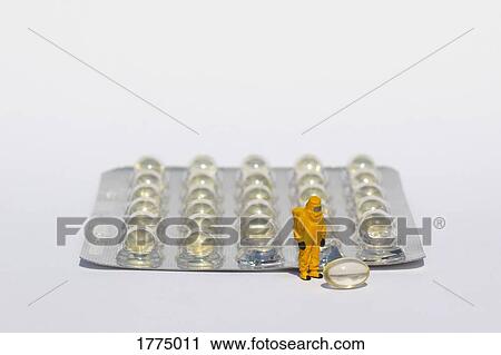Small scientist in clean suit examining gel capsules from blister pack View Large Photo Image Stock Image - Small scientist in clean suit examining gel capsules from blister pack. Fotosearch
