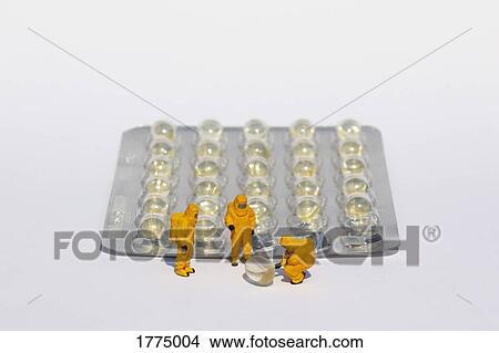 Small scientists in clean suits examining gel capsules from blister pack View Large Photo Image Picture - Small scientists in clean suits examining gel capsules from blister pack. Fotosearch