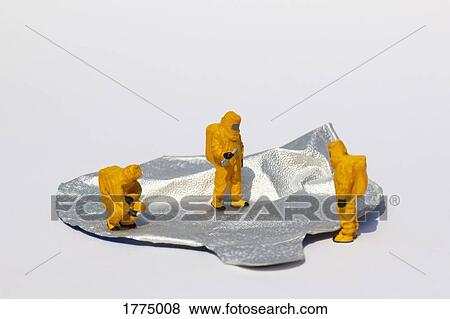 Small scientists in clean suits examining foil yogurt lid View Large Photo Image Stock Photo - Small scientists in clean suits examining foil yogurt lid. Fotosearch