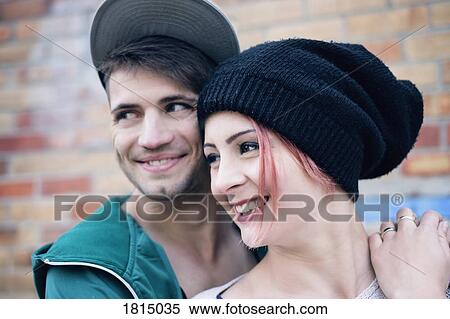 Smiling, affectionate young couple looking away View Large Photo Image Stock Photography - Smiling, affectionate young couple looking away. Fotosearch