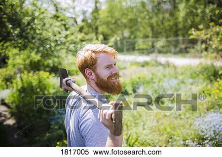 Smiling man with beard holding shovel in sunny garden View Large Photo Image Stock Photography - Smiling man with beard holding shovel in sunny garden. Fotosearch