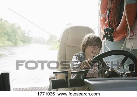 Smiling, playful girl sitting on riding lawn mower View Large Photo Image Stock Photograph - Smiling, playful girl sitting on riding lawn mower. Fotosearch