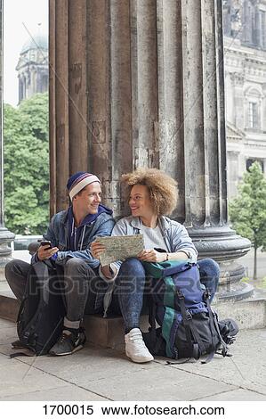 Smiling young tourist sitting with map at Altes Museum, Berlin, Germany View Large Photo Image Stock Photography - Smiling young tourist sitting with map at Altes Museum, Berlin, Germany. Fotosearch