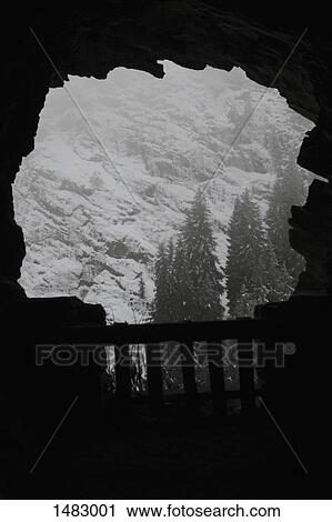 Snow covered mountain seen from cave View Large Photo Image Stock Image - Snow covered mountain seen from cave. Fotosearch