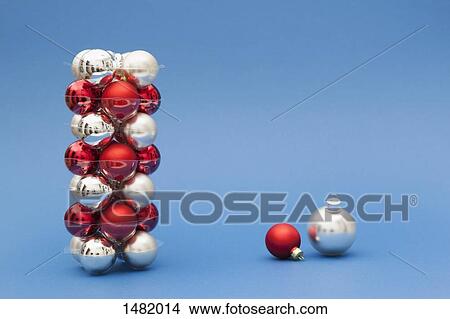 Stack of red and silver colored Christmas ornaments on blue background View Large Photo Image Picture - Stack of red and silver colored Christmas ornaments on blue background. Fotosearch