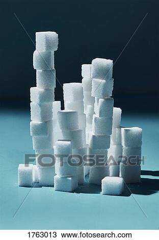 Stacked sugar cubes on blue background View Large Photo Image Stock Image - Stacked sugar cubes on blue background. Fotosearch