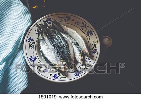 Still life fresh salted, whole sardines on plate View Large Photo Image Stock Photo - Still life fresh salted, whole sardines on plate. Fotosearch