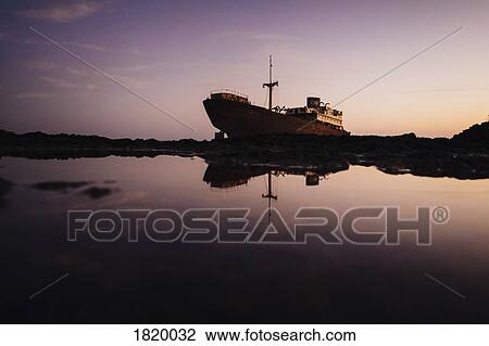 Stock Image - Stranded boat, Costa Teguise, Canary Islands, Spain. Fotosearch
