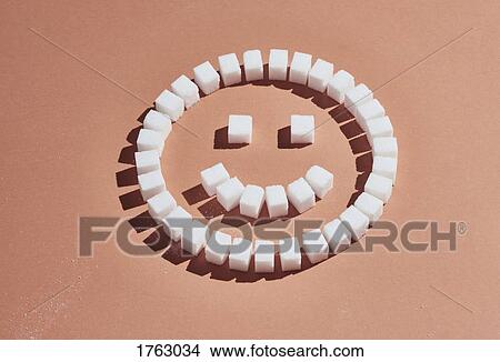 Sugar cubes forming smiley face on peach background View Large Photo Image Picture - Sugar cubes forming smiley face on peach background. Fotosearch