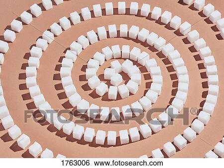 Sugar cubes forming spiral pattern on peach background View Large Photo Image Stock Photograph - Sugar cubes forming spiral pattern on peach background. Fotosearch