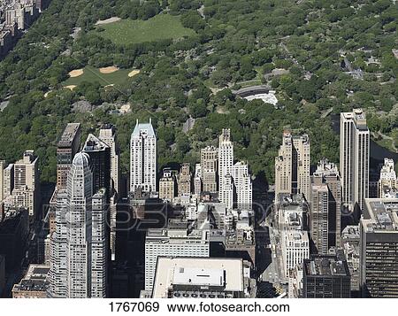 Sunny highrise buildings along Central Park, New York City, New York, USA View Large Photo Image Stock Photo - Sunny highrise buildings along Central Park, New York City, New York, USA. Fotosearch