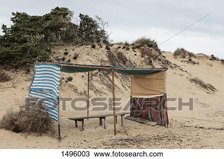 Sunshade and bench on a beach View Large Photo Image Stock Image - Sunshade and bench on a beach. Fotosearch