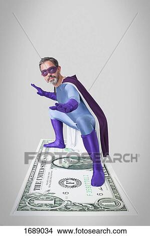Superhero bending with arms outstretched and legs apart on artificial American one dollar View Large Photo Image Picture - Superhero bending with arms outstretched and legs apart on artificial American one dollar. Fotosearch