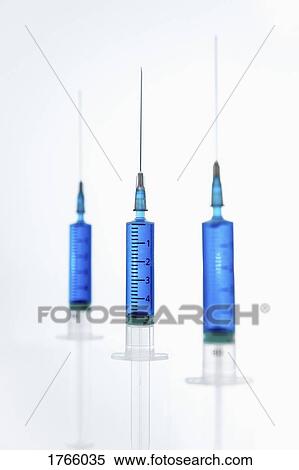 Syringes with blue liquid View Large Photo Image Stock Photography - Syringes with blue liquid. Fotosearch