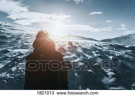 Teenage boy standing on sunny, snow covered mountain, Reykjadalur, Iceland View Large Photo Image Stock Image - Teenage boy standing on sunny, snow covered mountain, Reykjadalur, Iceland. Fotosearch