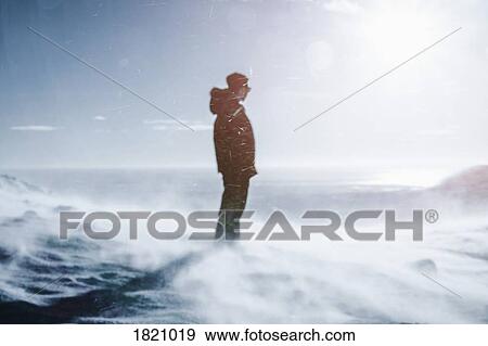Teenage boy standing on sunny, windy snow covered mountain, Reykjadalur, Iceland View Large Photo Image Stock Photo - Teenage boy standing on sunny, windy snow covered mountain, Reykjadalur, Iceland. Fotosearch