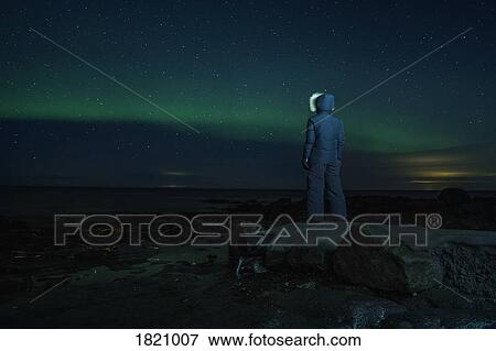 Teenage boy watching Northern Lights from rock, Reykjanesbaer, Iceland View Large Photo Image Stock Photo - Teenage boy watching Northern Lights from rock, Reykjanesbaer, Iceland. Fotosearch
