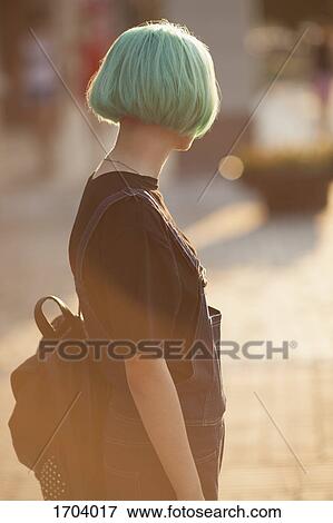 Teenage girl carrying backpack while standing in city during sunny day View Large Photo Image Stock Photo - Teenage girl carrying backpack while standing in city during sunny day. Fotosearch