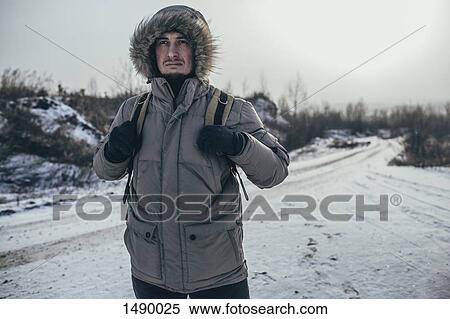 Thoughtful hiker carrying backpack while standing on snow covered landscape View Large Photo Image Stock Photography - Thoughtful hiker carrying backpack while standing on snow covered landscape. Fotosearch