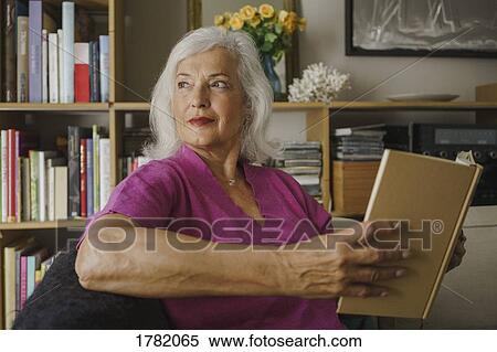 Thoughtful senior woman reading book View Large Photo Image Stock Photography - Thoughtful senior woman reading book. Fotosearch