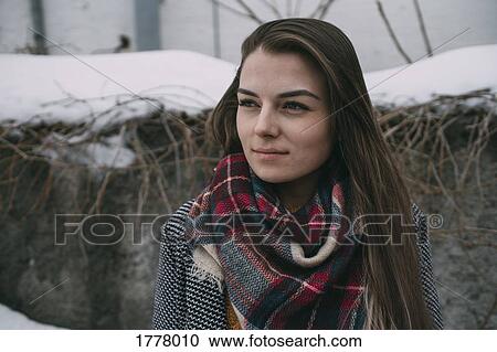 Thoughtful young woman in plaid scarf looking away View Large Photo Image Stock Image - Thoughtful young woman in plaid scarf looking away. Fotosearch