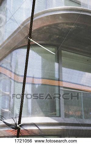 Tour boat seen through netting View Large Photo Image Stock Photograph - Tour boat seen through netting. Fotosearch