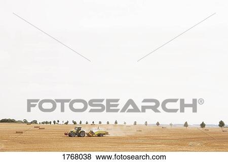 Tractor in rural hay field, Wiendorf, Mecklenburg-Vorpommern, Germany View Large Photo Image Stock Photo - Tractor in rural hay field, Wiendorf, Mecklenburg-Vorpommern, Germany. Fotosearch