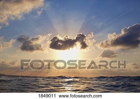 Stock Image - Tranquil sunset in cloudy sky over ocean, Sayulita, Nayarit, Mexico. Fotosearch