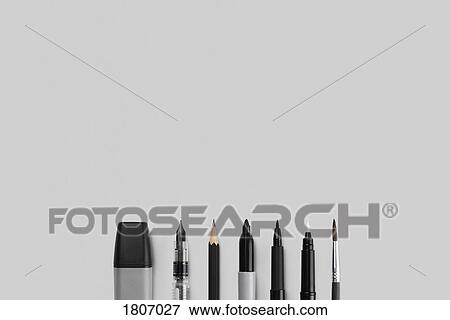 Variety of writing and drawing instruments in a row on gray background View Large Photo Image Stock Photo - Variety of writing and drawing instruments in a row on gray background. Fotosearch