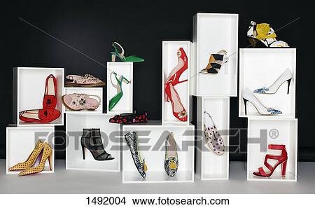 Various pair of shoes in boxes arranged against black background View Large Photo Image Picture - Various pair of shoes in boxes arranged against black background. Fotosearch