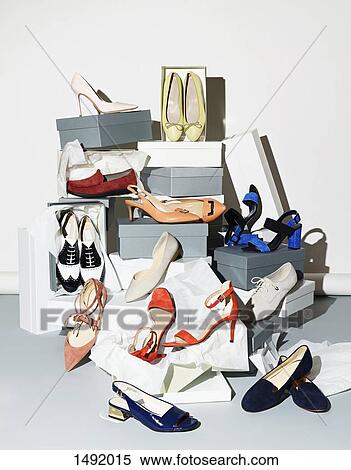 Stock Photography - Various pair of shoes with boxes against white background. Fotosearch