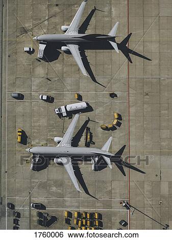 View from above commercial airplane being serviced, prepared on tarmac at airport View Large Photo Image Stock Photograph - View from above commercial airplane being serviced, prepared on tarmac at airport. Fotosearch