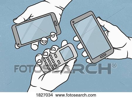 Picture - View from above hands holding cell phone and smart phones. Fotosearch