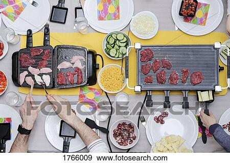View from above raclette grills, preparing food View Large Photo Image Stock Photo - View from above raclette grills, preparing food. Fotosearch