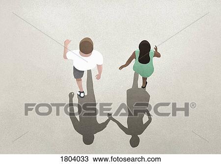 View from above shadow of couple holding hands View Large Photo Image Stock Image - View from above shadow of couple holding hands. Fotosearch
