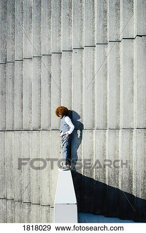View from above young man with afro laying on sunny urban steps View Large Photo Image Stock Photo - View from above young man with afro laying on sunny urban steps. Fotosearch
