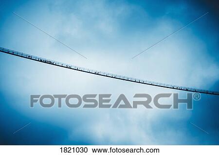View from below suspension bridge against cloudy sky, Tyrol, Austria View Large Photo Image Stock Image - View from below suspension bridge against cloudy sky, Tyrol, Austria. Fotosearch