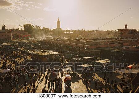 View of sunny, bustling souk market in Djemaa El Fna Square, Marrakesh, Morocco View Large Photo Image Stock Photo - View of sunny, bustling souk market in Djemaa El Fna Square, Marrakesh, Morocco. Fotosearch