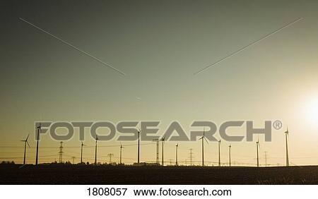 Wind turbines against sunny sunset sky, Brandenburg, Germany View Large Photo Image Stock Photo - Wind turbines against sunny sunset sky, Brandenburg, Germany. Fotosearch