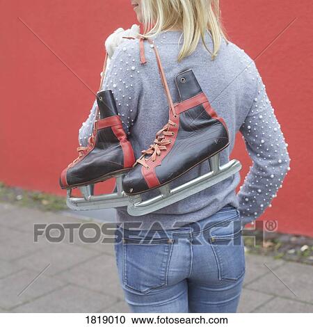 Woman carrying ice skates over shoulder View Large Photo Image Stock Image - Woman carrying ice skates over shoulder. Fotosearch